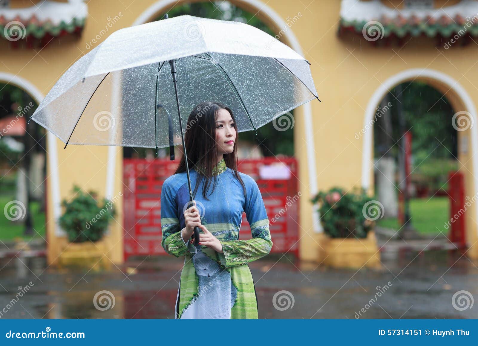 Vietnamese women wear Ao in the rain. Ao dai is famous 