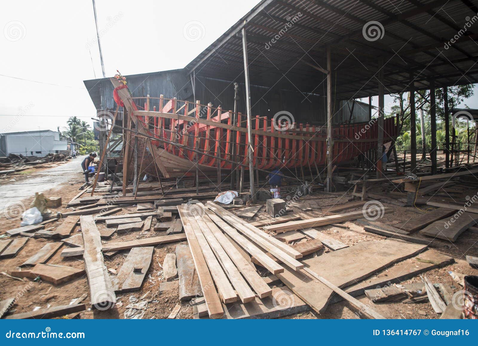 vietnamese workers build a large wooden boat in nga bay in