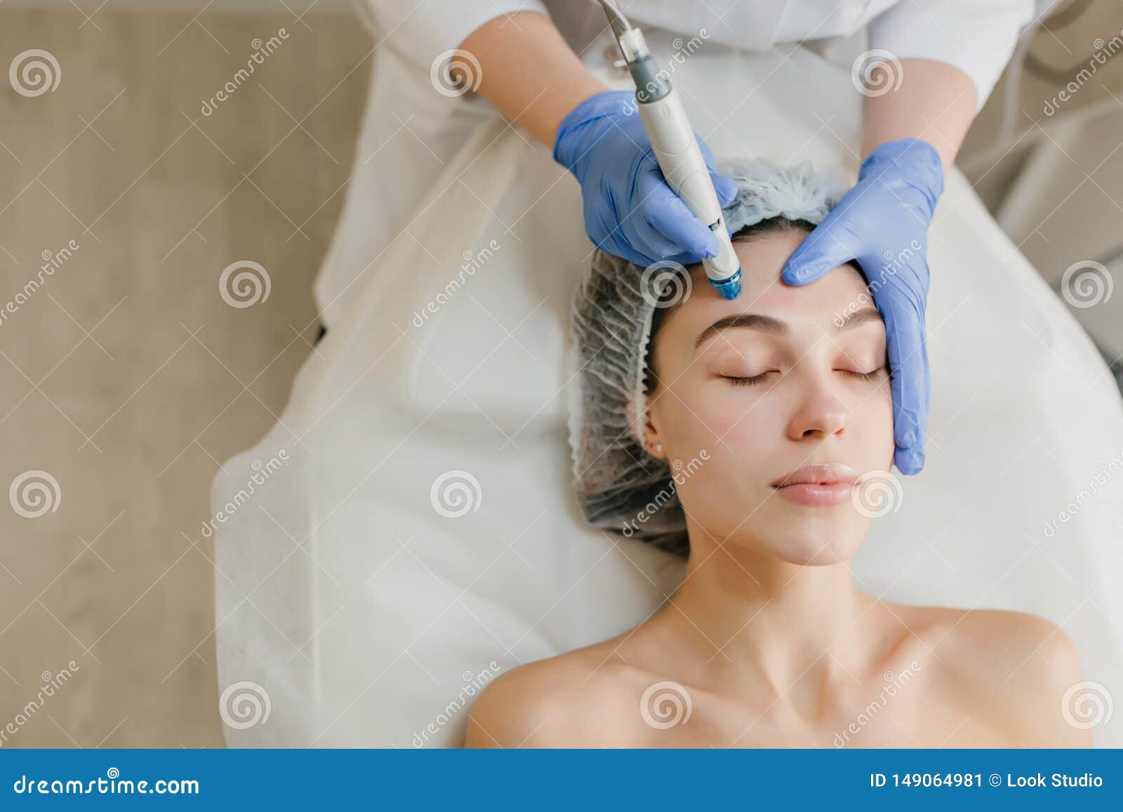 view from above of beautiful woman enjoying cosmetology procedures, rejuvenation in beauty salon. dermatology, doctor at