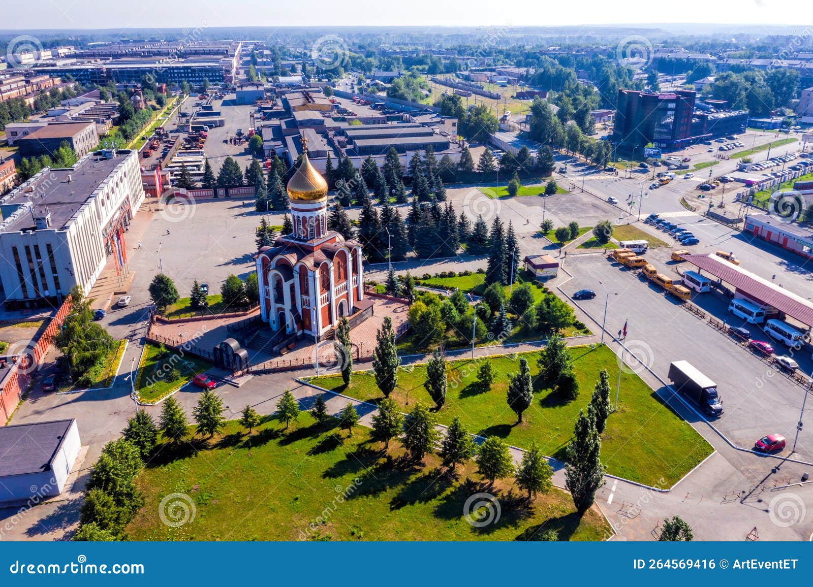 view from above over square of the of the machine-building plant and the church with golden domes