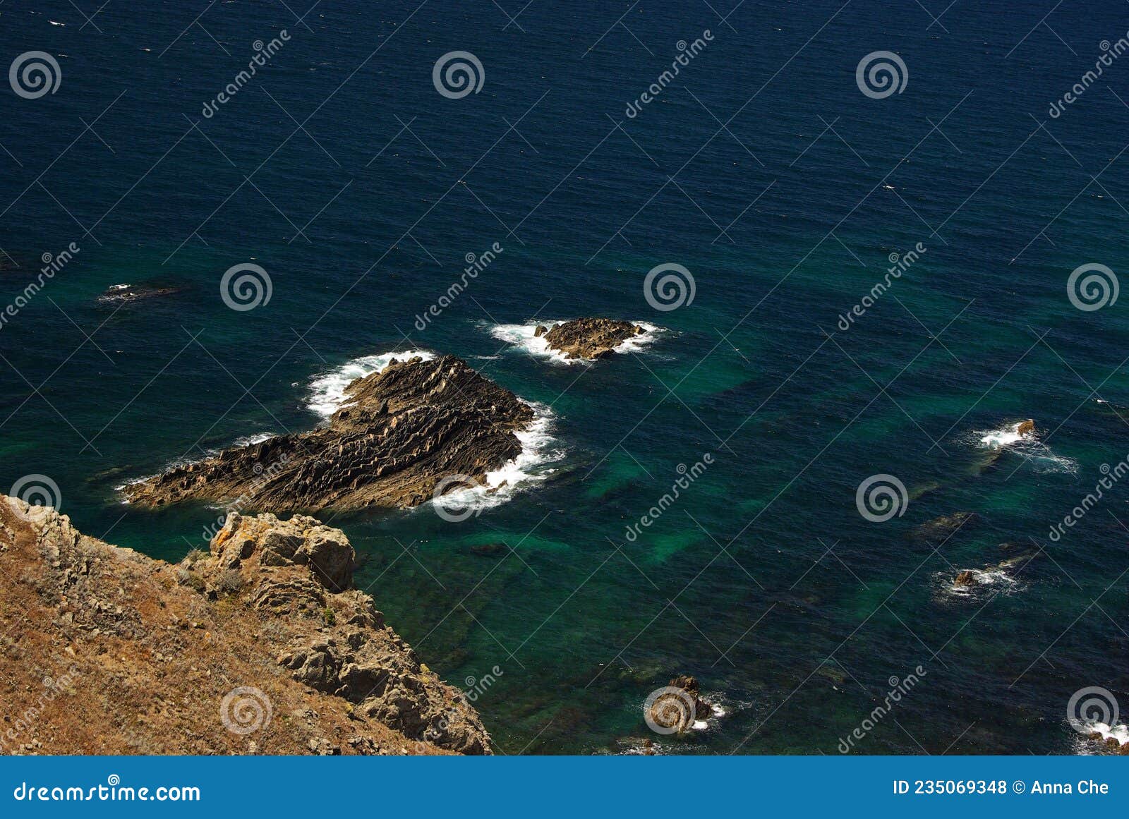 a view from above on the rocks of arrifana bay with ransparent turquose water