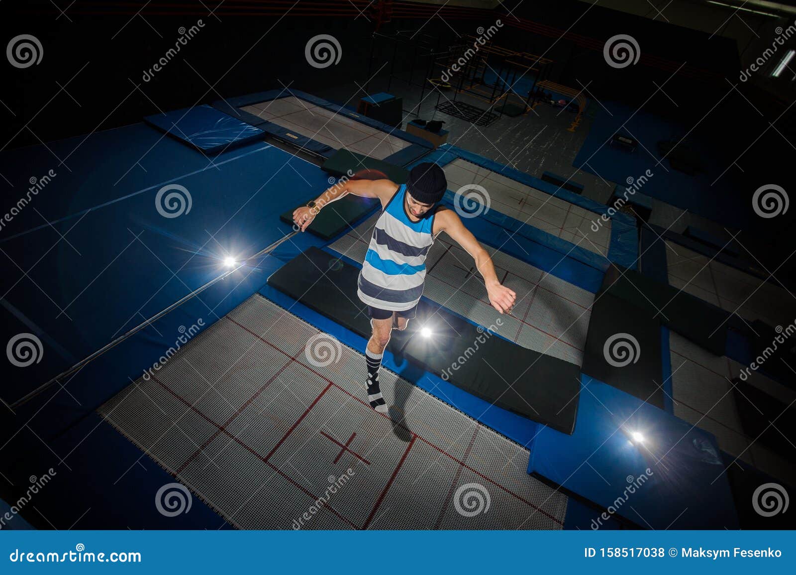 View From Above Young Man Jumping On The Trampoline Floor In The