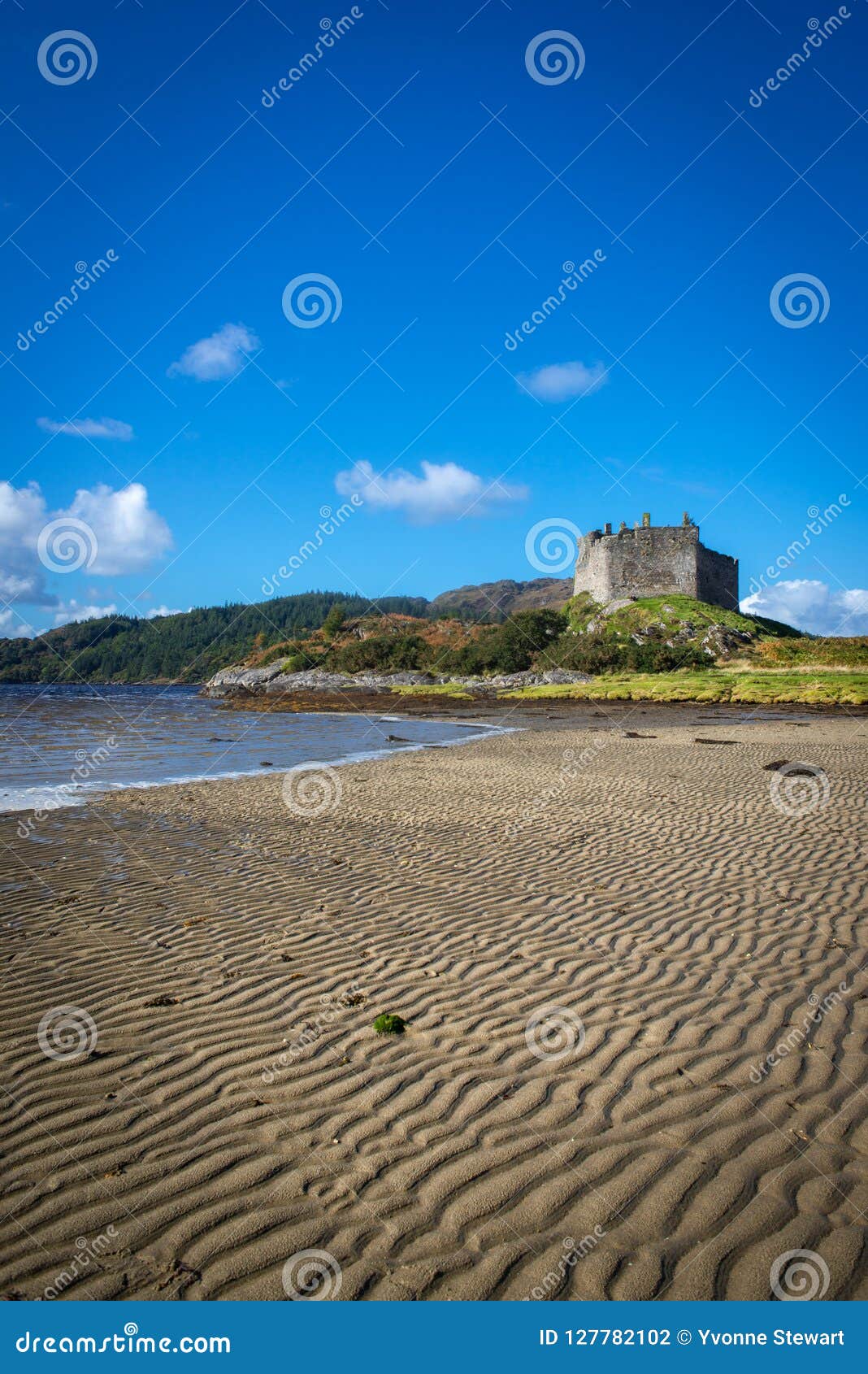 view across the beach towards castle tiorum on a sunny day at lo