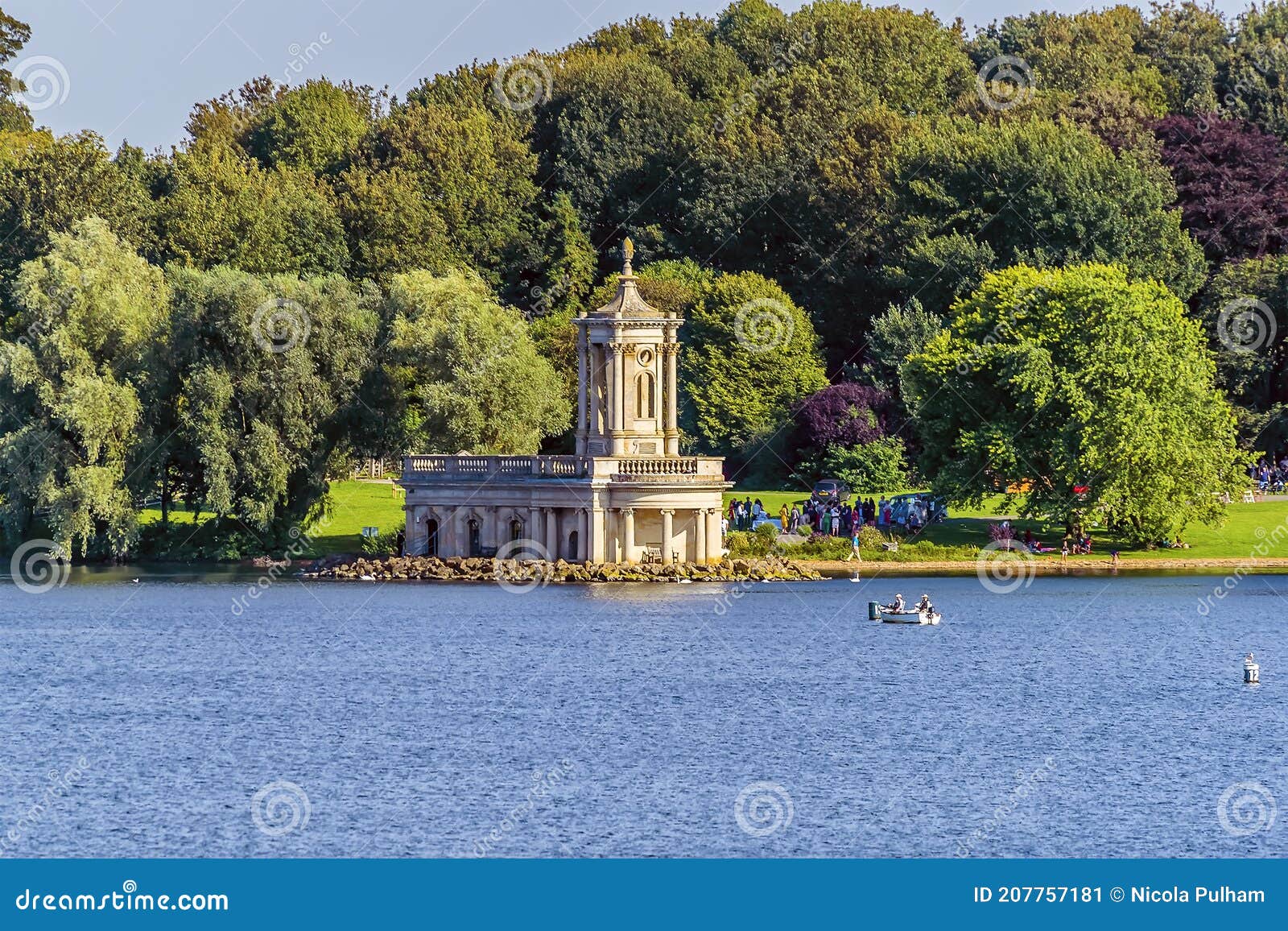 a view across rutland water reservoir towards normanton church highlighted by the evening sun