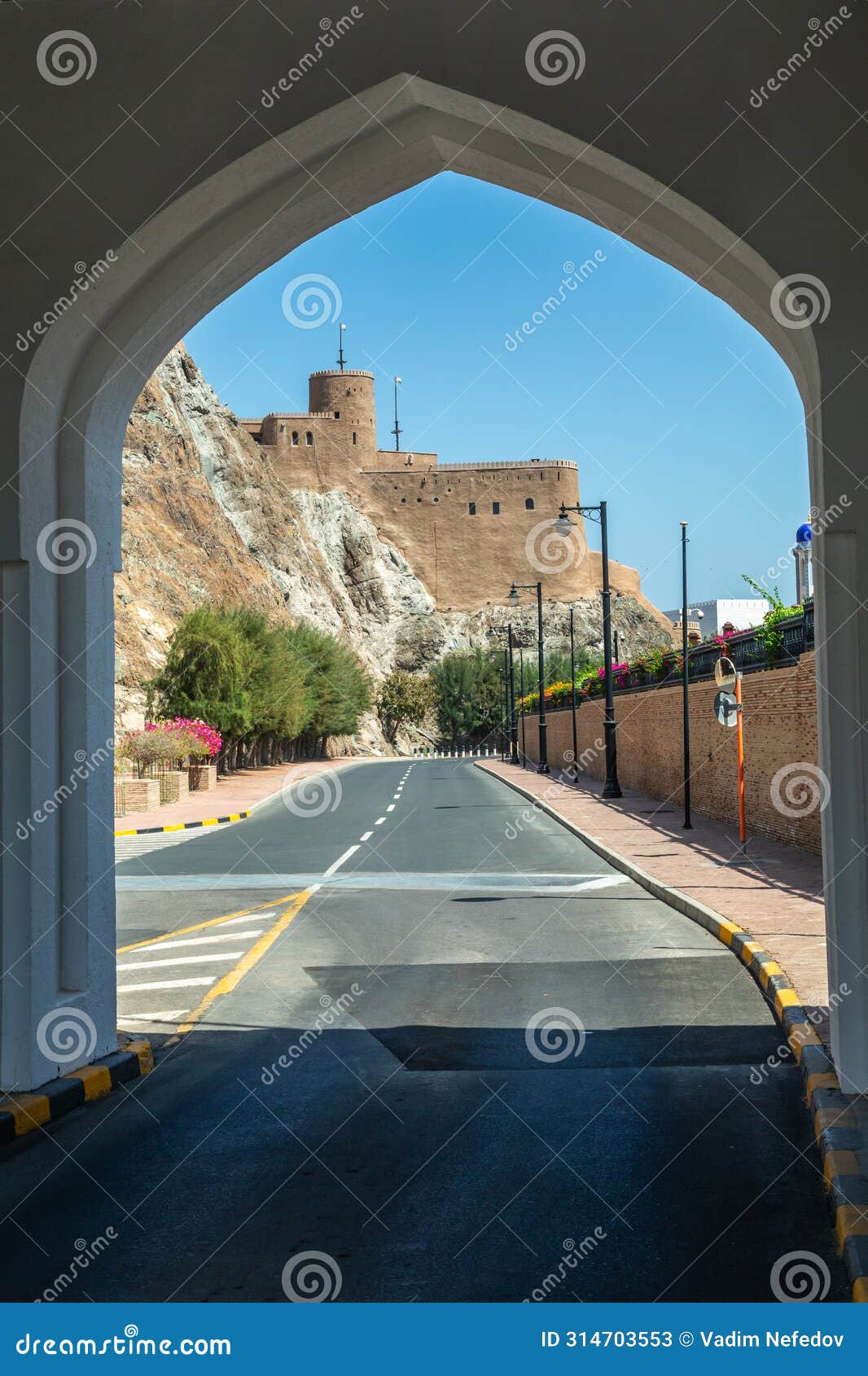 view from the arch to the al mirani castle on the rock standing on the rock, muscat, oman