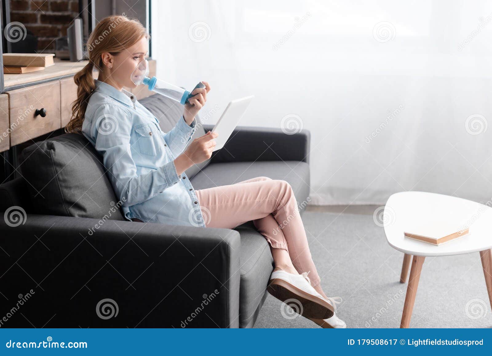 view of asthmatic woman using inhaler