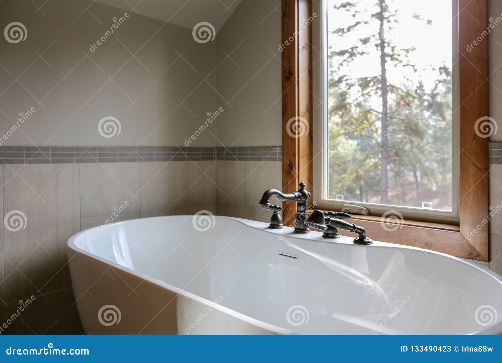 View Of Bathroom Design With A White Sleek Freestanding Tub Stock