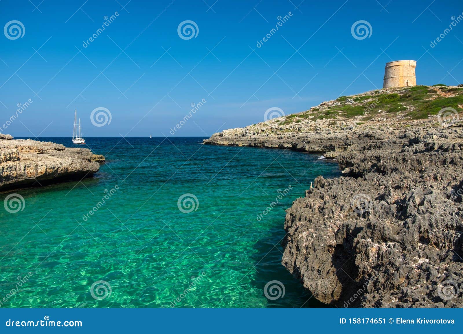 view on the beach calo roig and the defense tower alcaufar on menorca