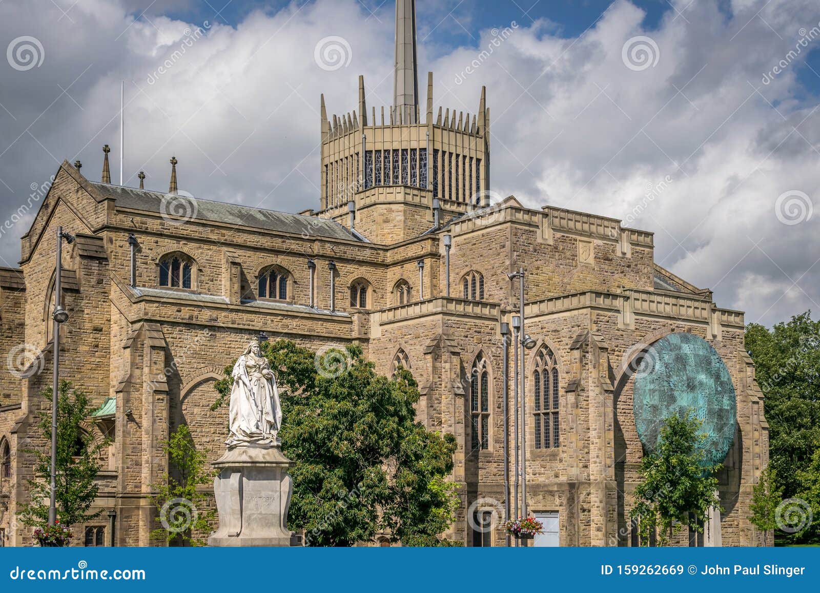 a view of blackburn cathedral with statue of queen victoria