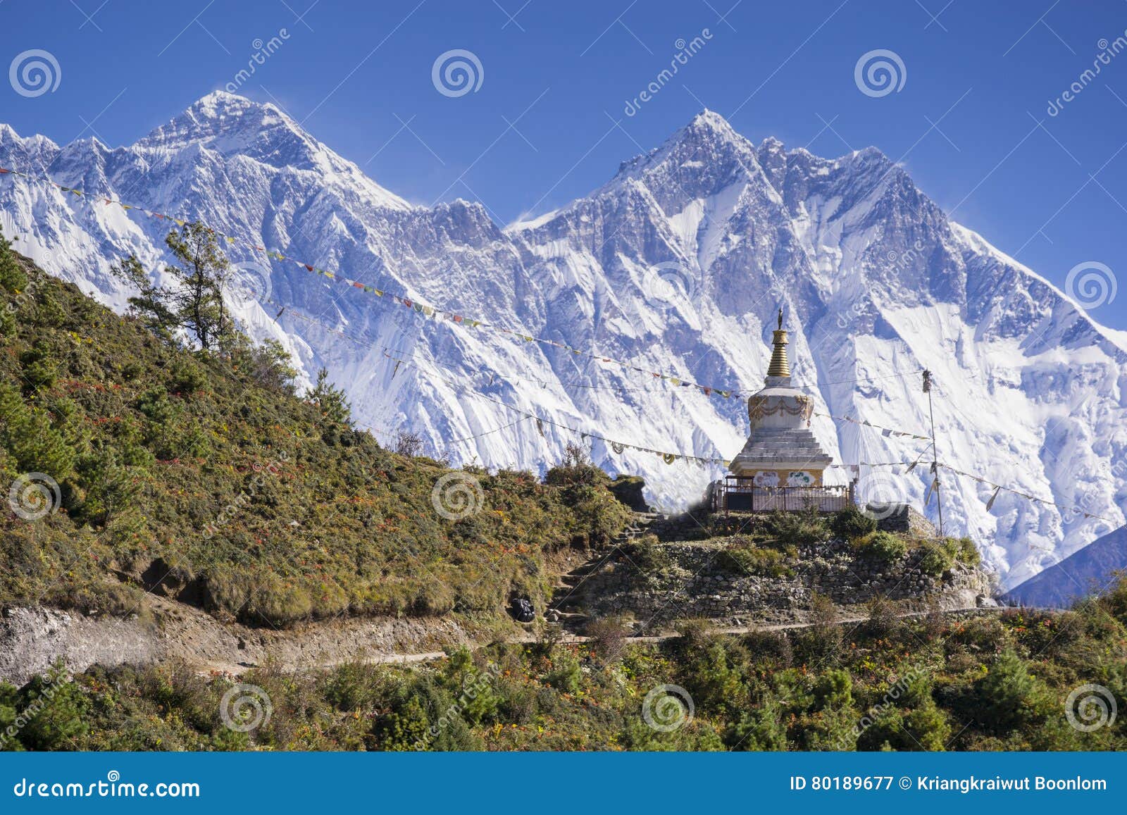 view of a buddhist stupa with mountain lhotse and ama dablam behind on the way from namche bazaar to tengboche.