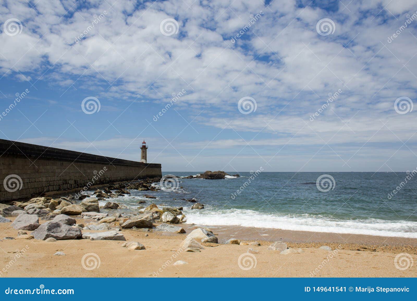 view from carneiro beach in porto to pier and lighthouse felgueiras