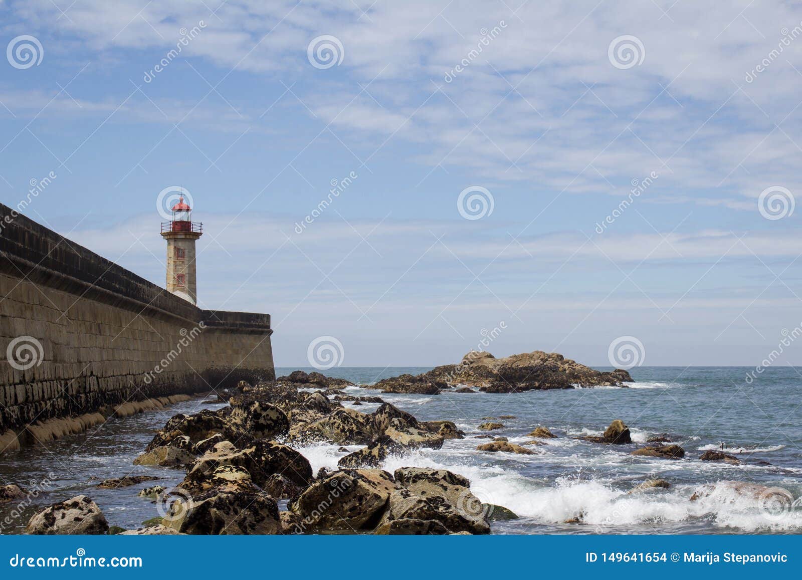 view from carneiro beach in porto to pier and lighthouse felgueiras