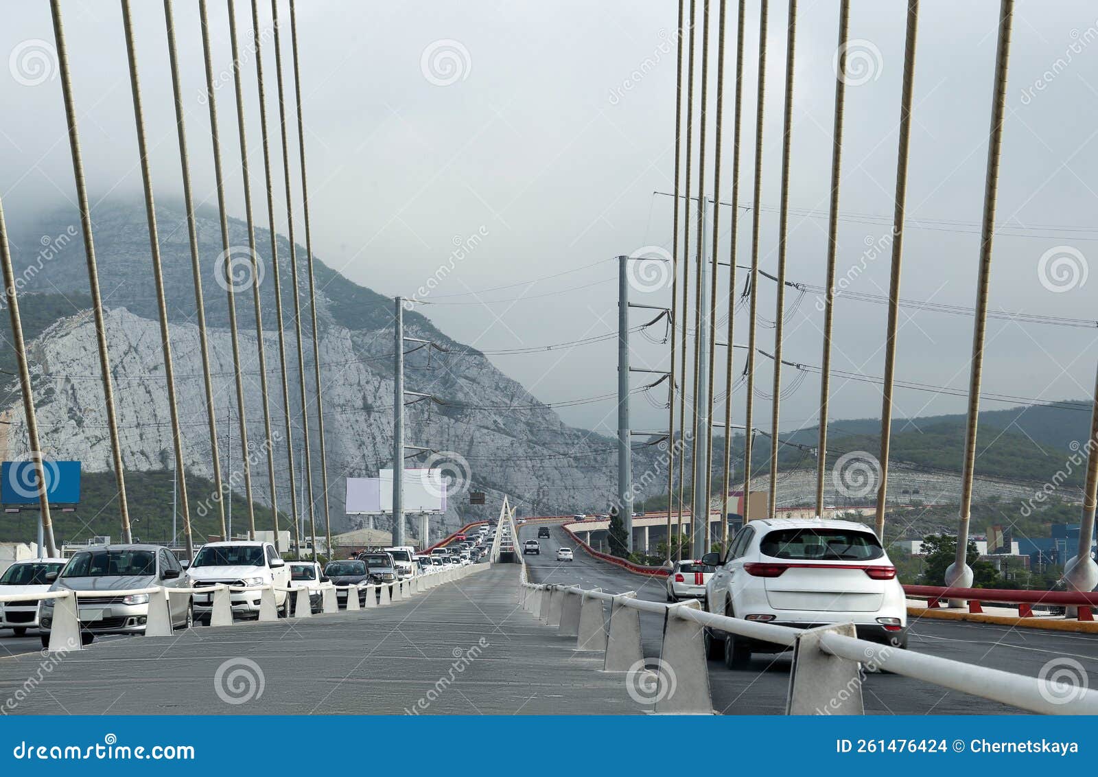 view of cars on modern bridge near mountain