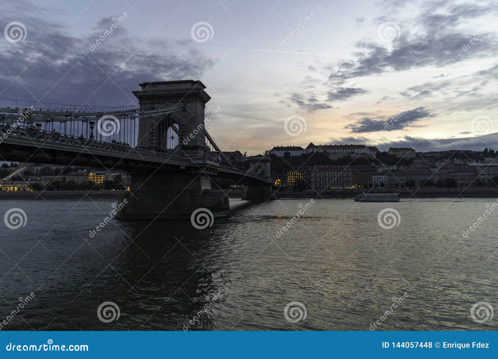 view of the chain bridge at dusk from the pest riverbank, budapest, hungary