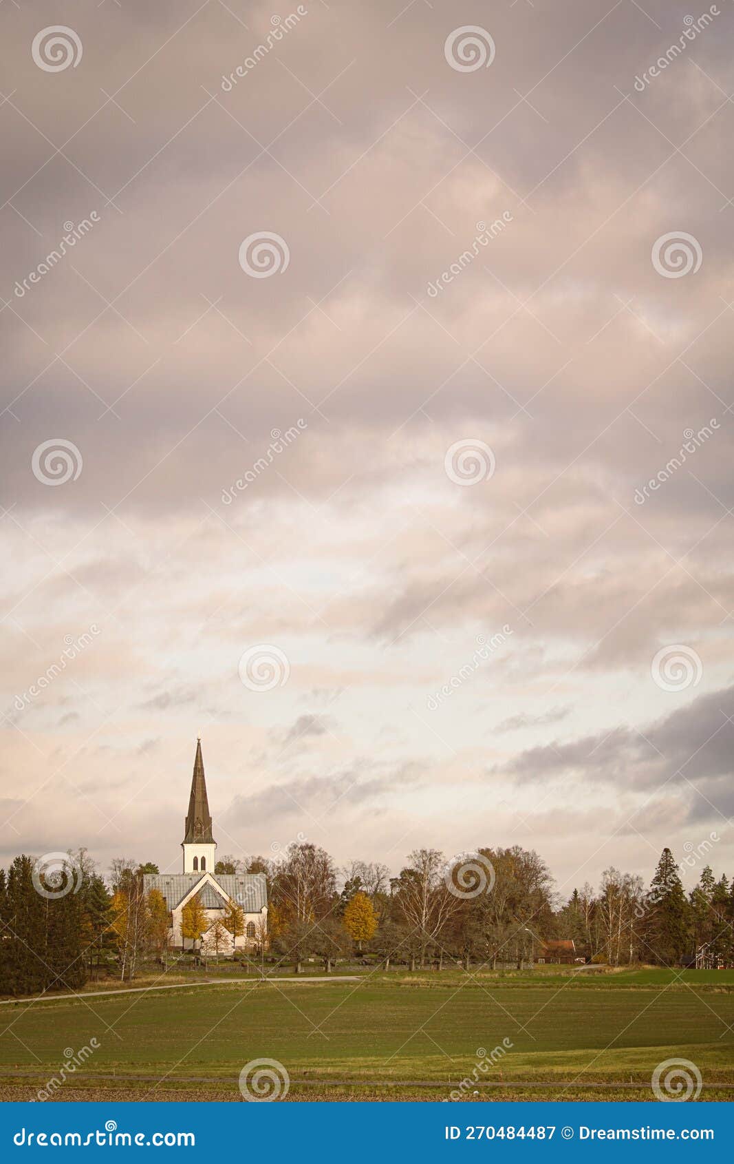 view of church on field against cloudy sky
