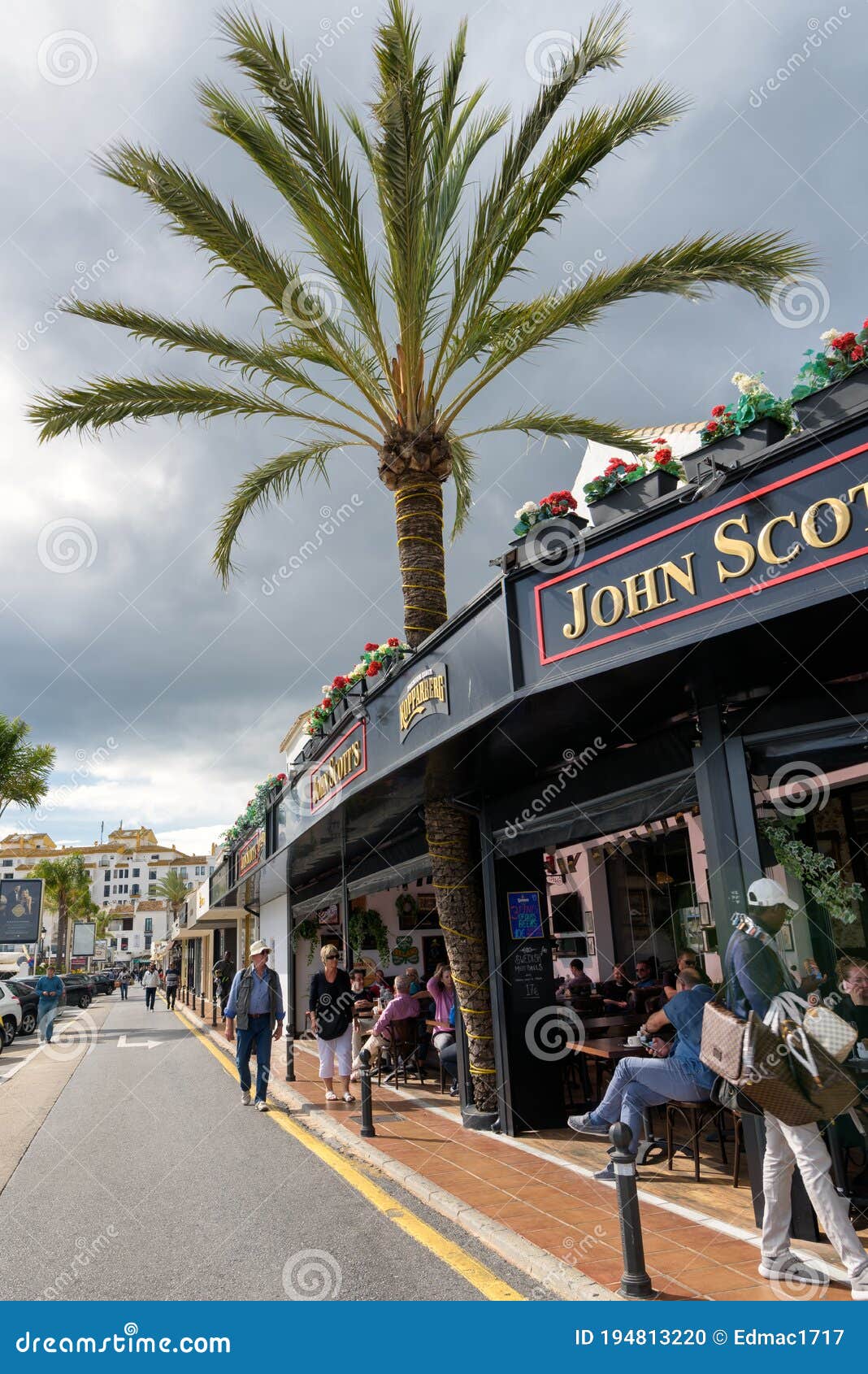 View of City Street Lined with Restaurants in Puerto Banus, Marbella,  Spain. Editorial Image - Image of people, exterior: 194813220