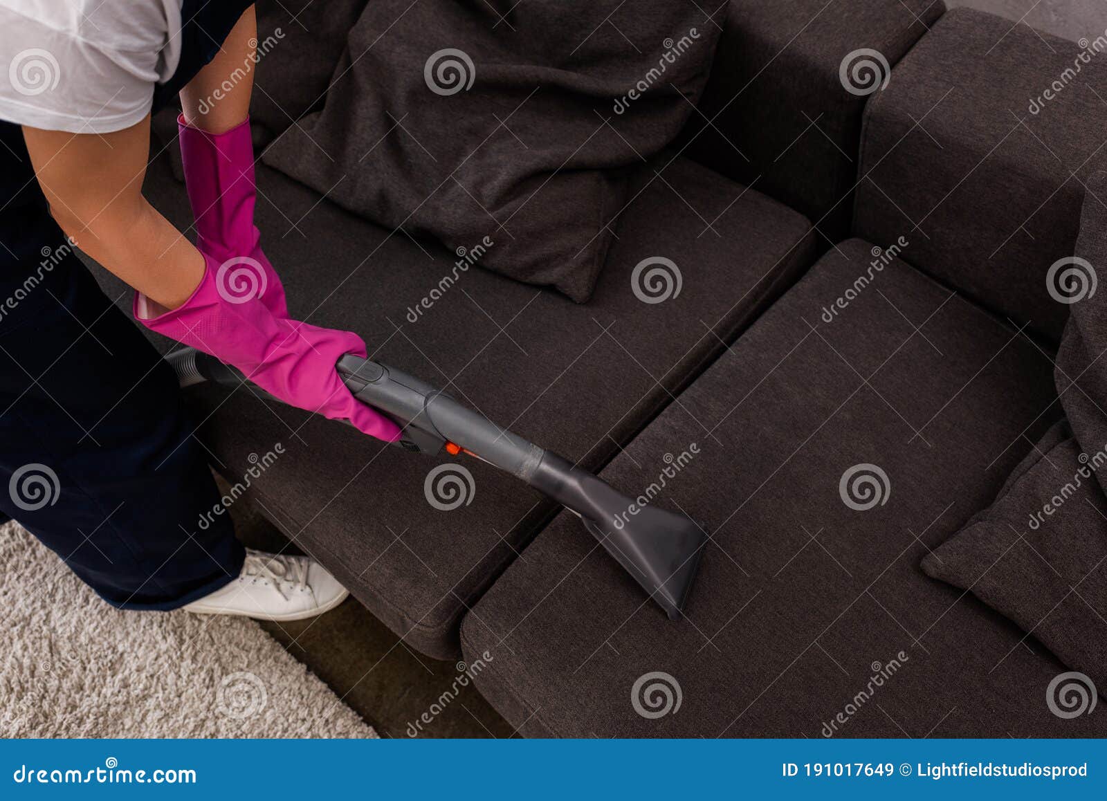 View of Cleaner Using Vacuum Cleaner on Upholstery of Couch Stock Image