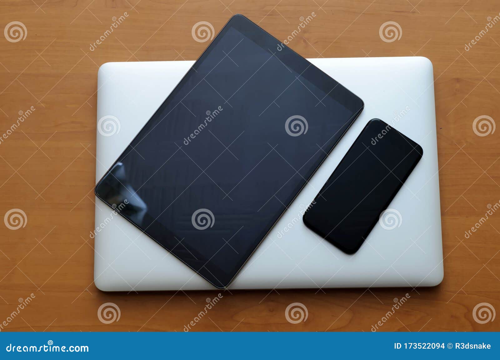 View On A Closed Laptop Pc On A Desk With A Smartphone And Tablet