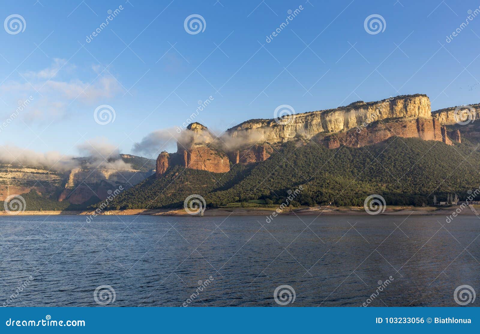 view of colorful sheer cliffs above sau reservoir near tavertet in catalonia, spain