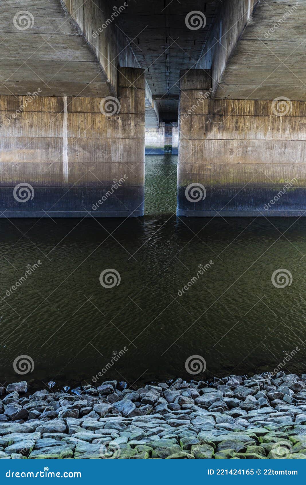 view of the concrete columns from under a bridge