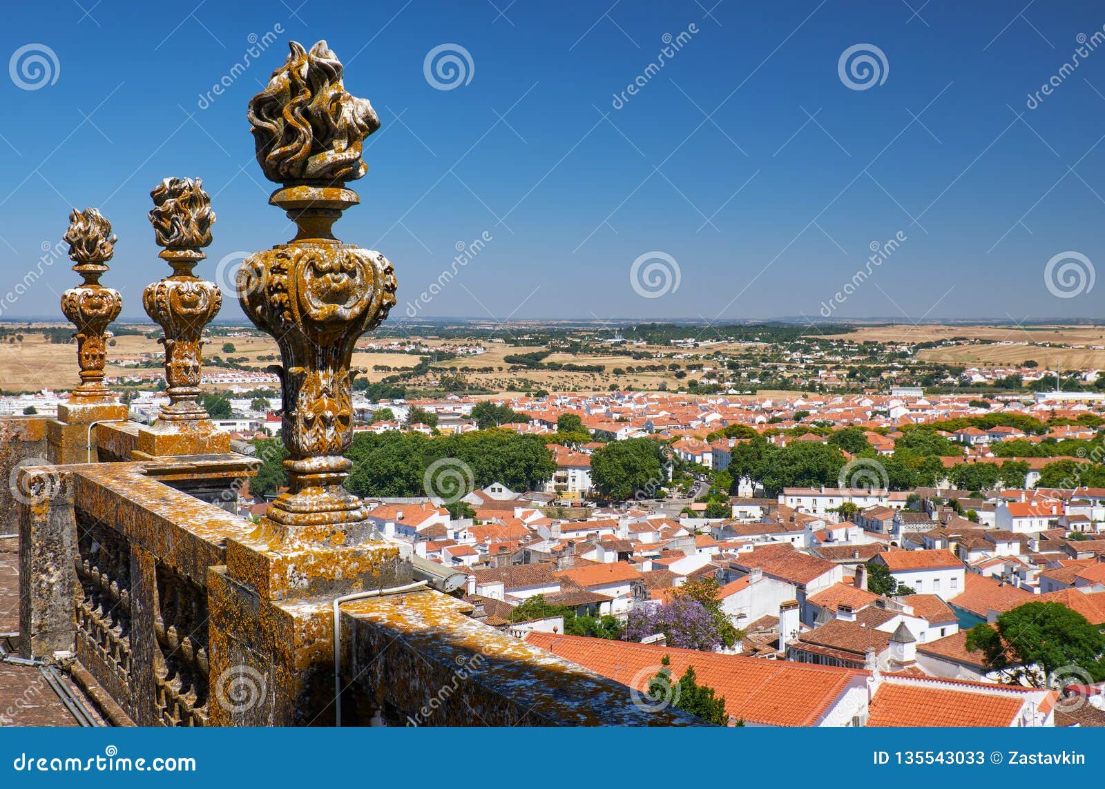 decorative stone torches on the balcony of evora cathedral (se). evora. portugal