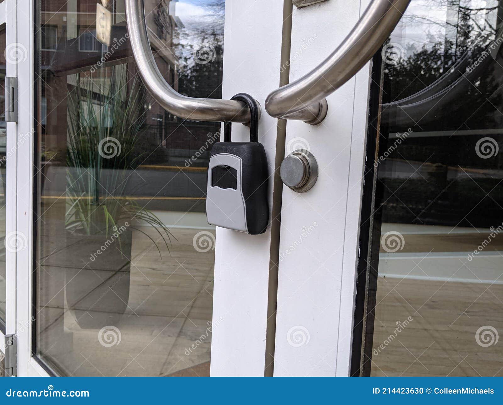 View of a Digital Padlock on Glass Office Building Doors Stock Photo