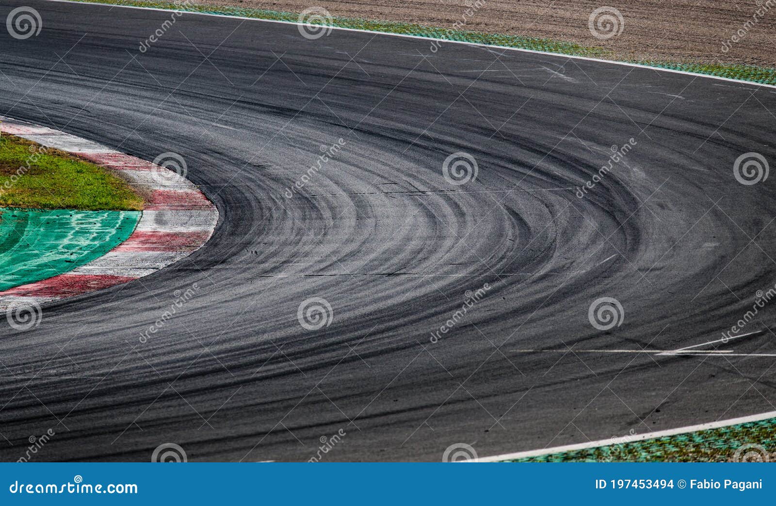 view of empty black asphalt track motor sport circuit with red curb at corner