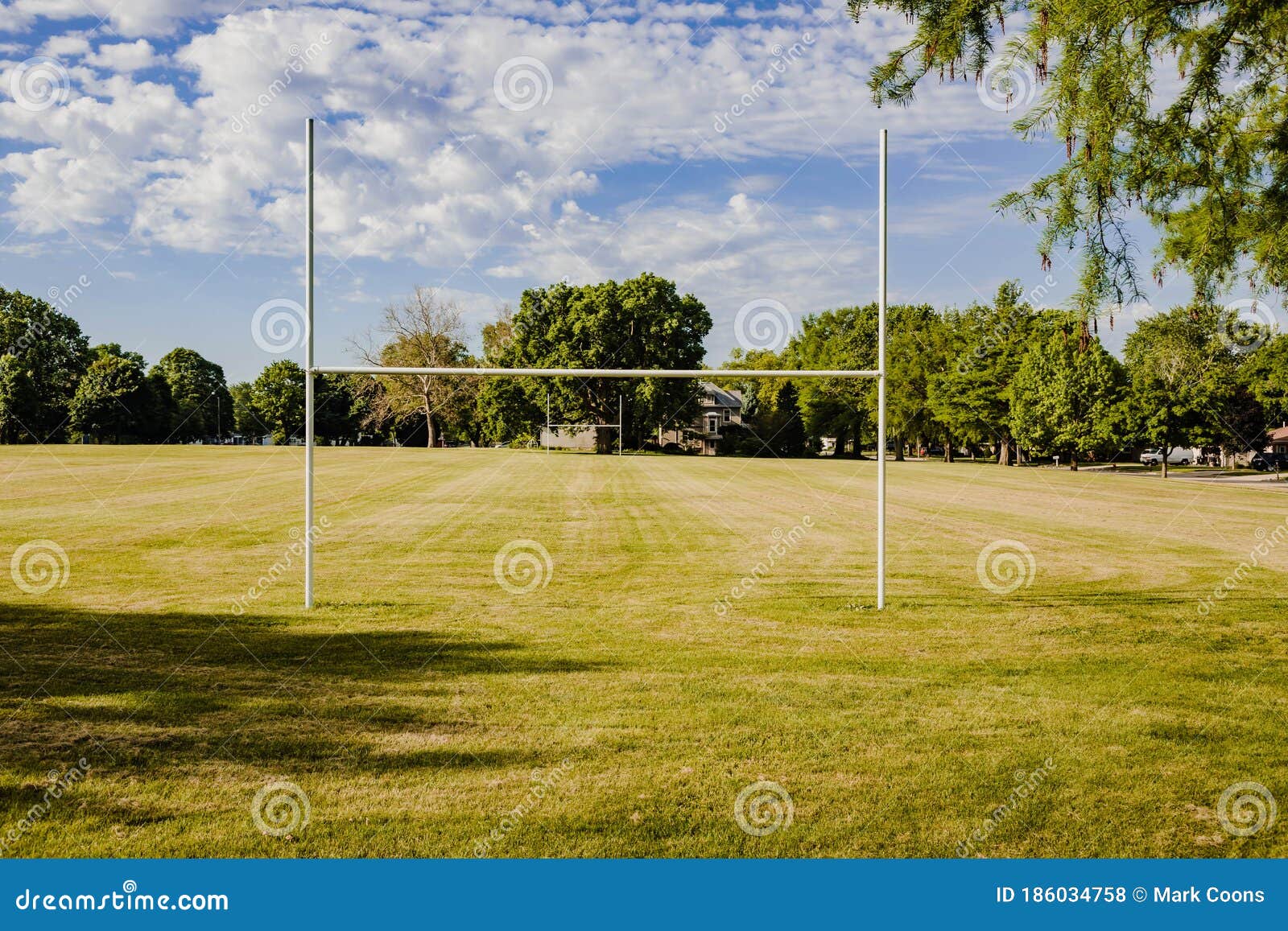 The view from the end zone of a youth football field in a city park