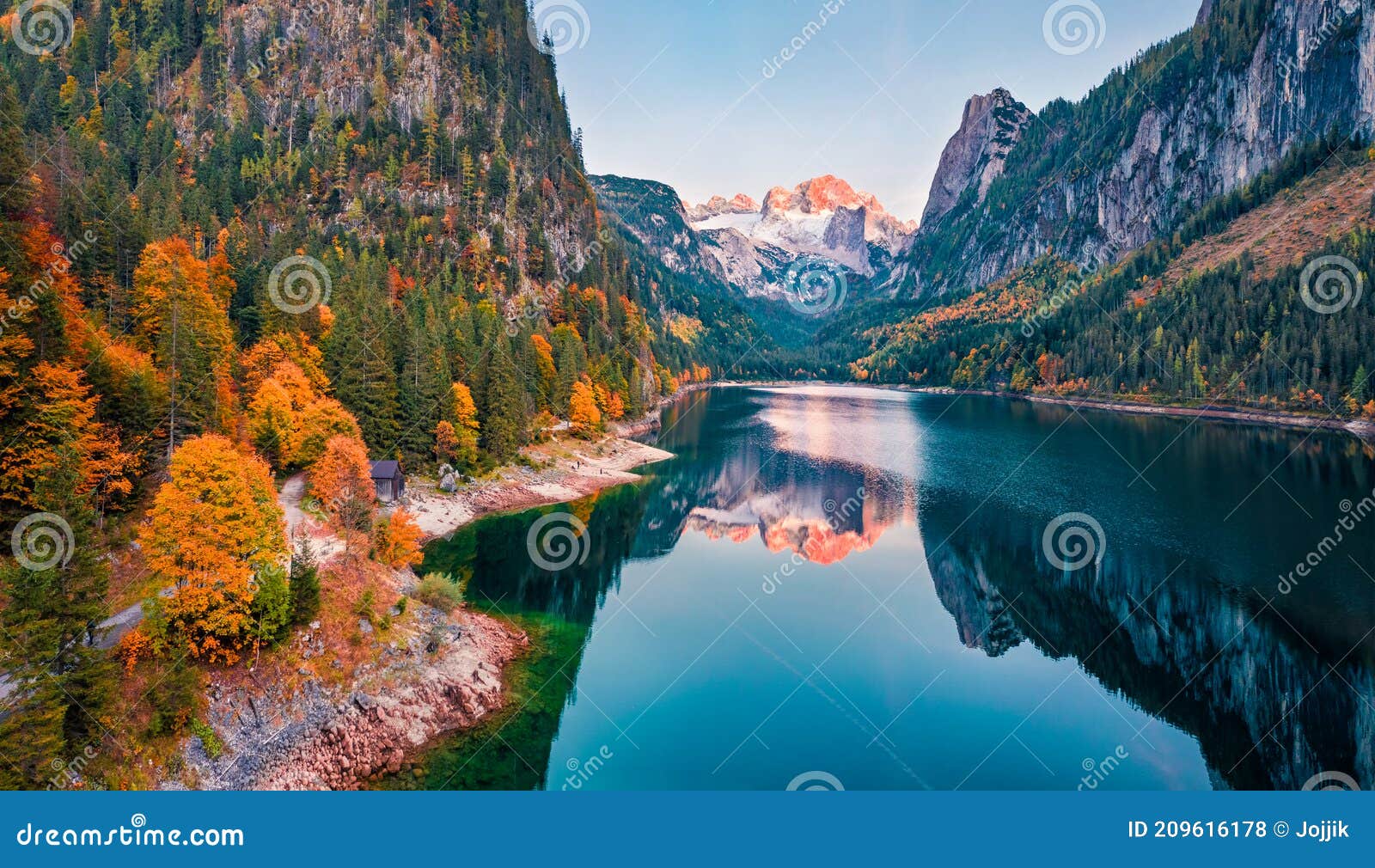 view from flying drone. captivating autumn view of gosausee vorderer lake with dachstein glacieron background. spectacular eveni