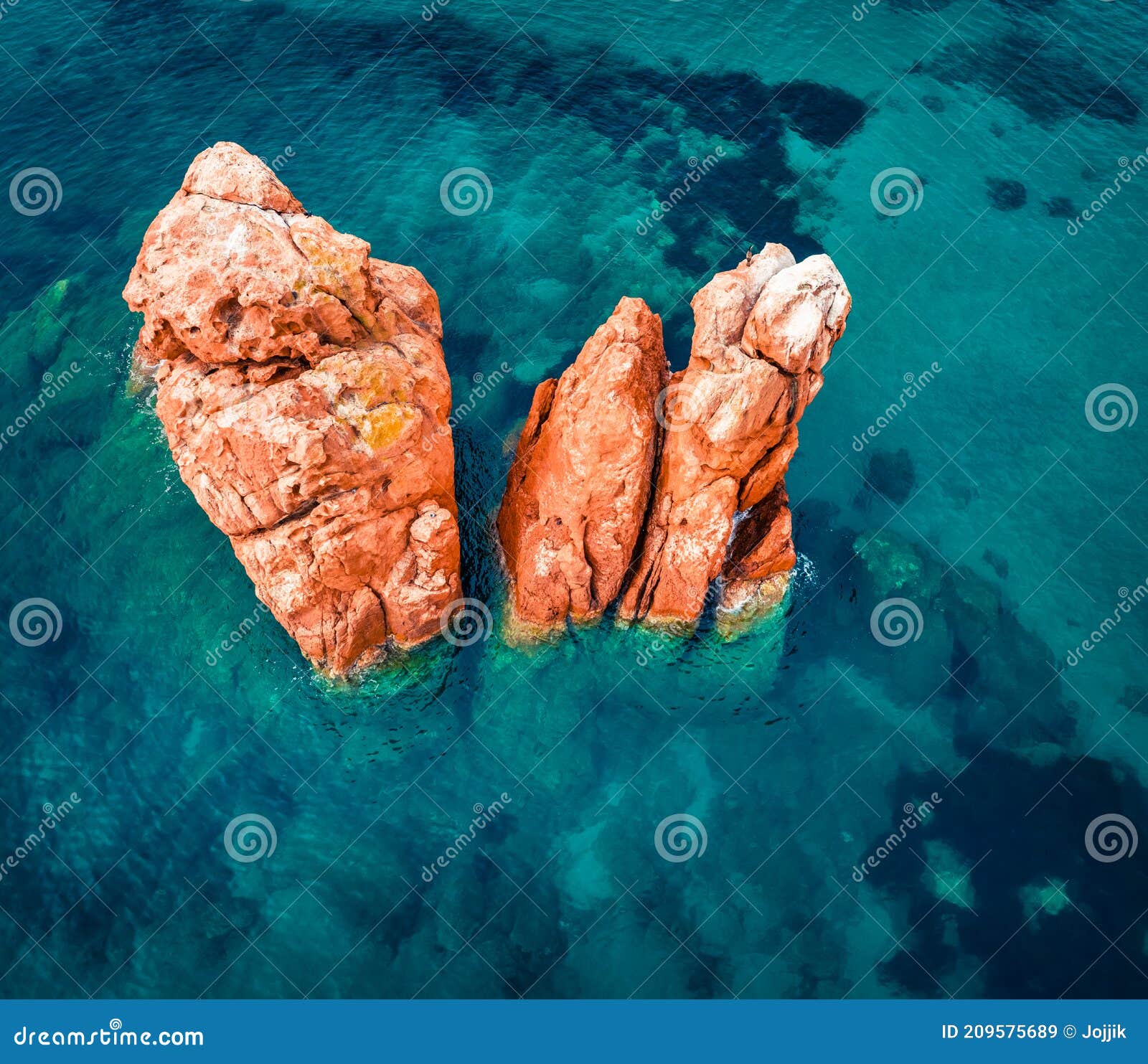 view from flying drone. colorful summer view of red rocks gli scogli rossi - faraglioni on the di cea beach. aerial morning scene