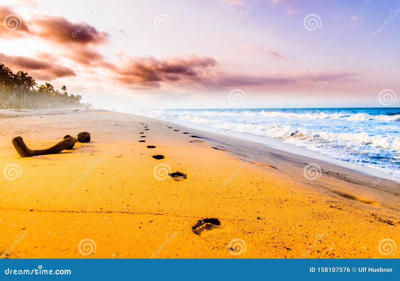 view on foodsteps and sunset on the beach by tayrona in colombia
