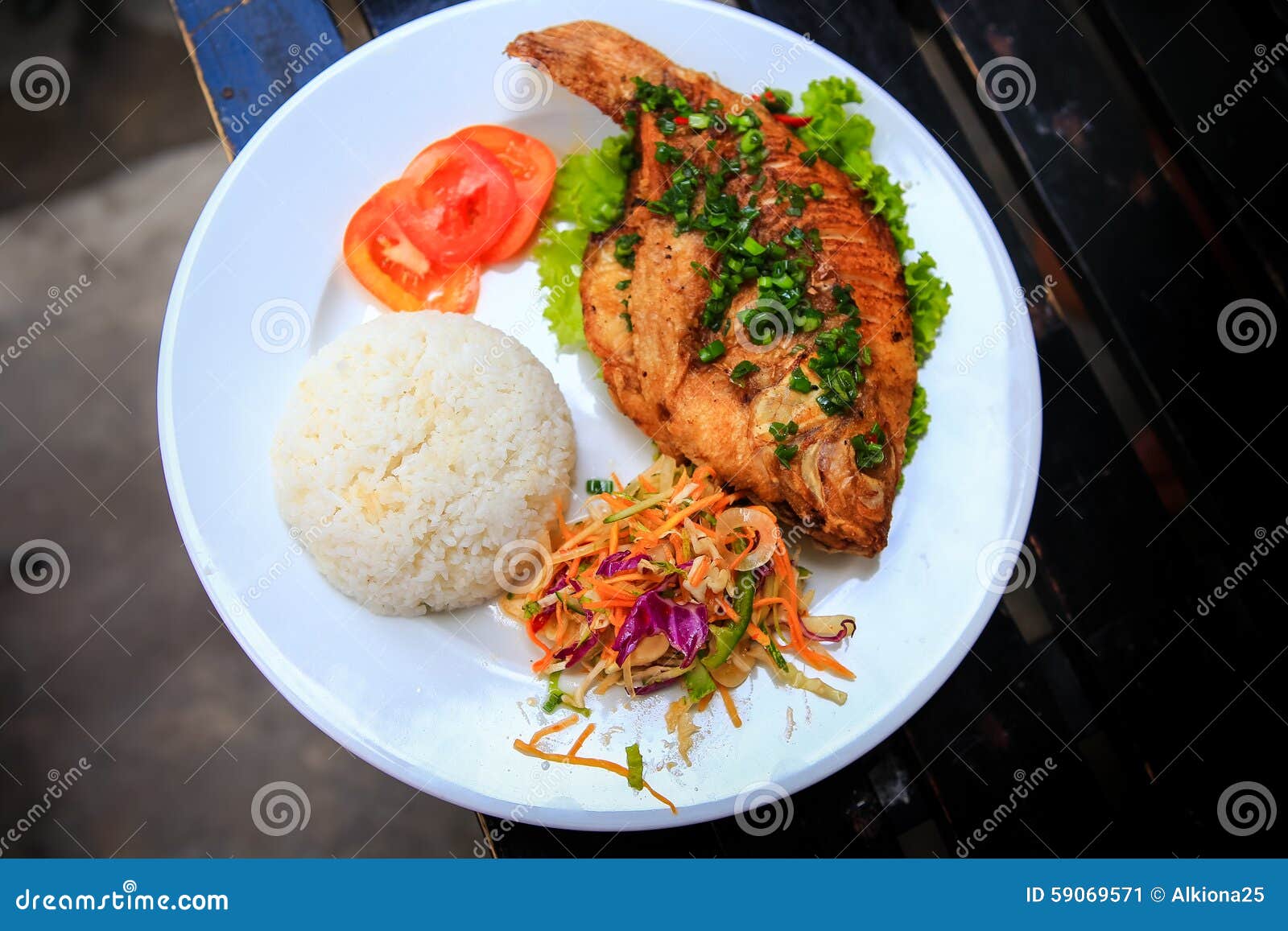 View of Fried Fish with Rice Vegetables on White Plate Stock Image