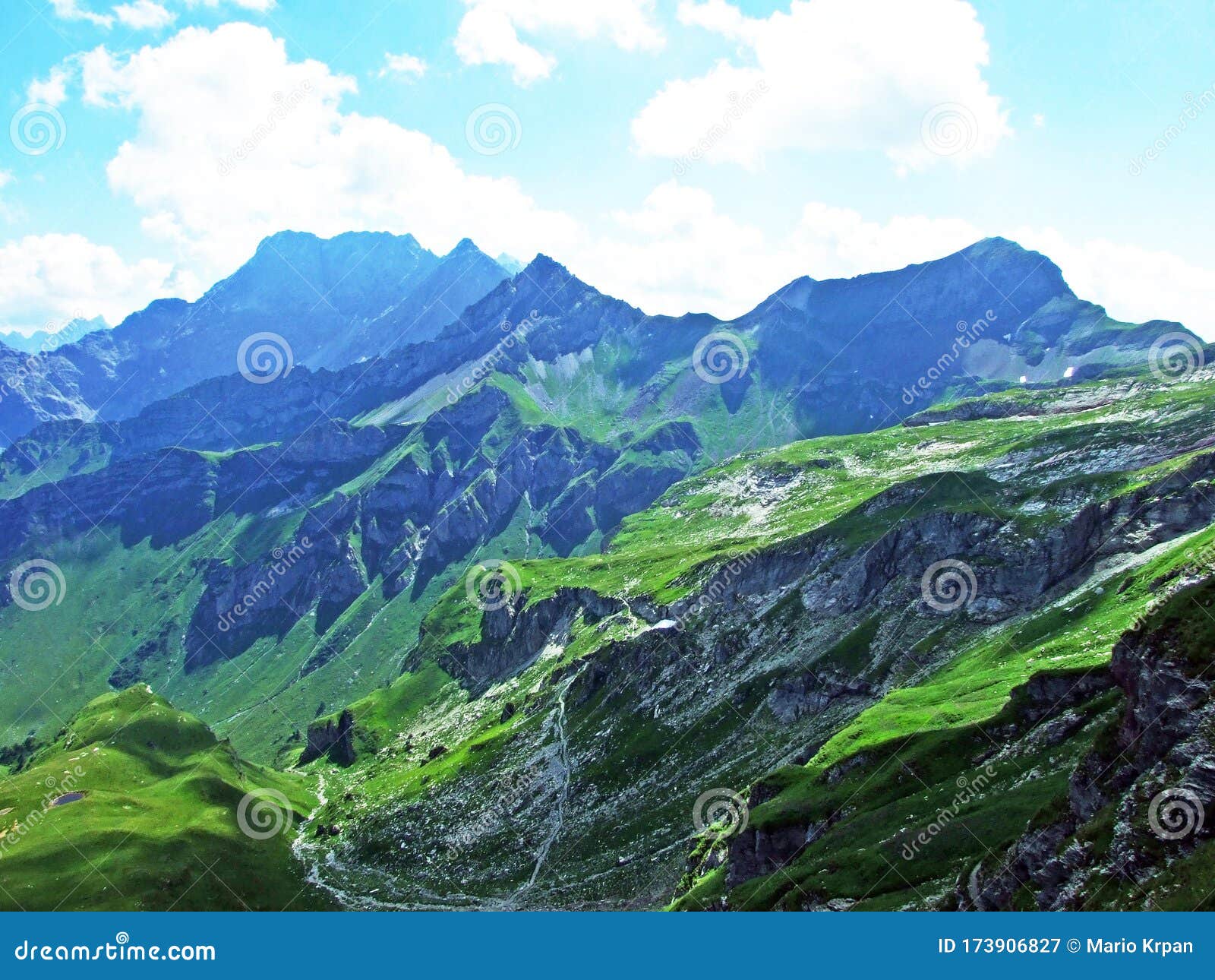 view of the gamperdonatal alpine valley and the austrian alps from the naafkopf peak in the liechtenstein alps - steg