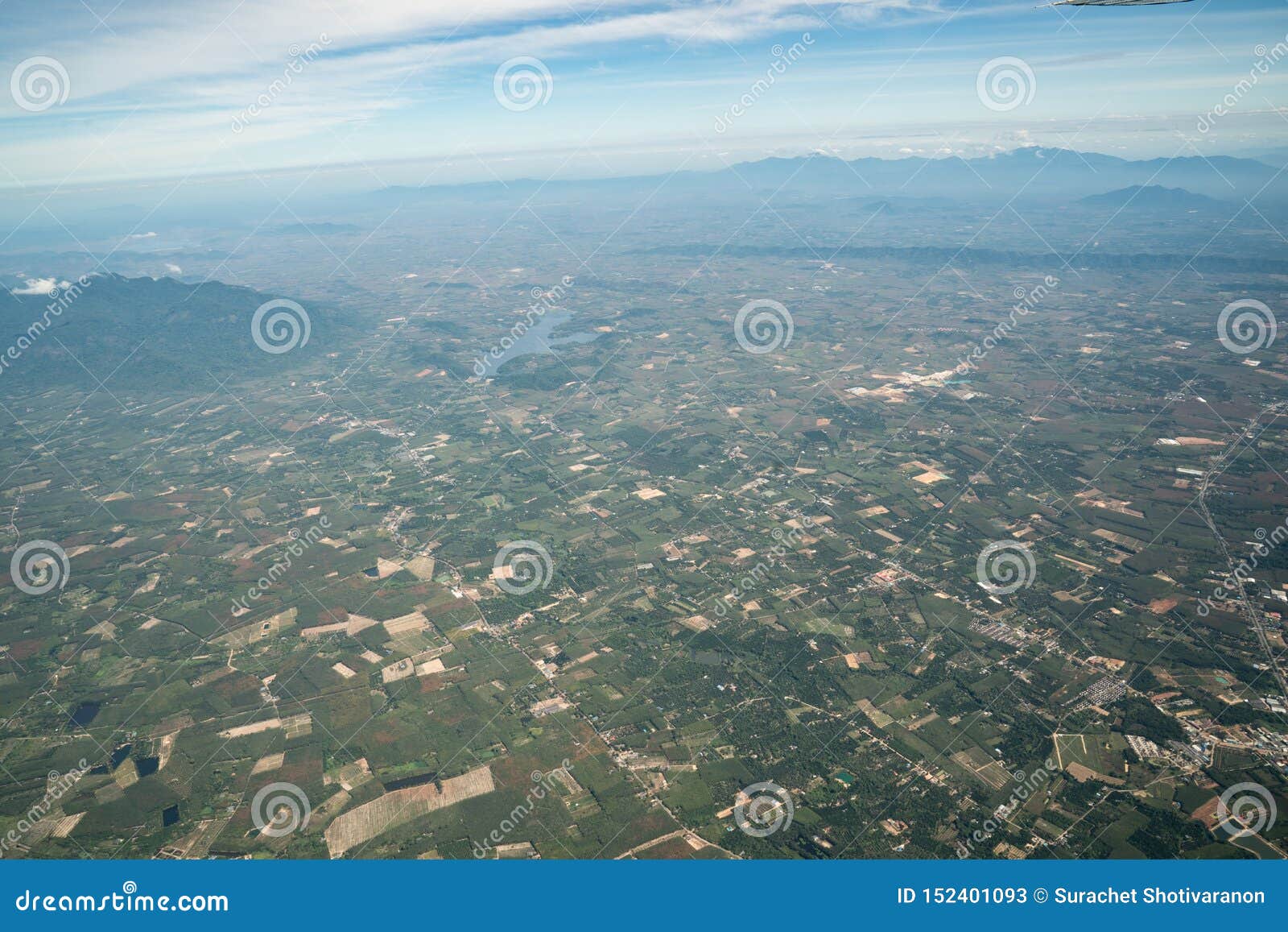 the view of green field and farm and city downtown in middle of thailand. it shot from jetplane