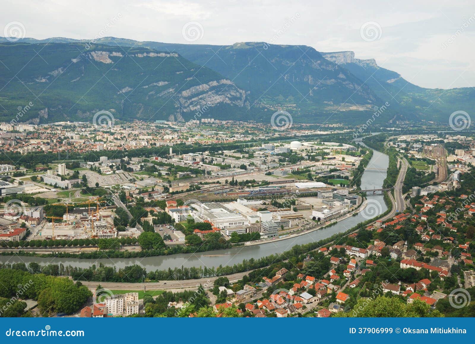 view of grenoble with the river and mountains.