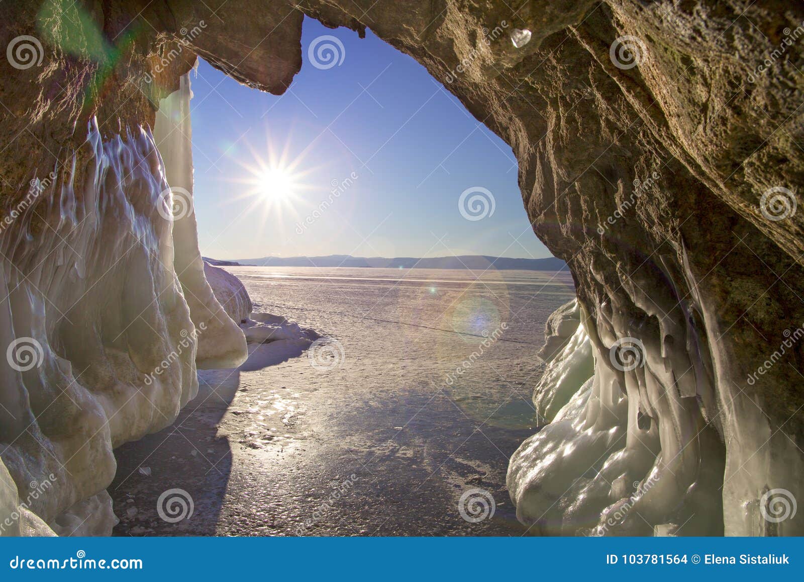 the view from the grotto with icicles, chunks of ice and hummocks to the sun and blye sky. natural background.
