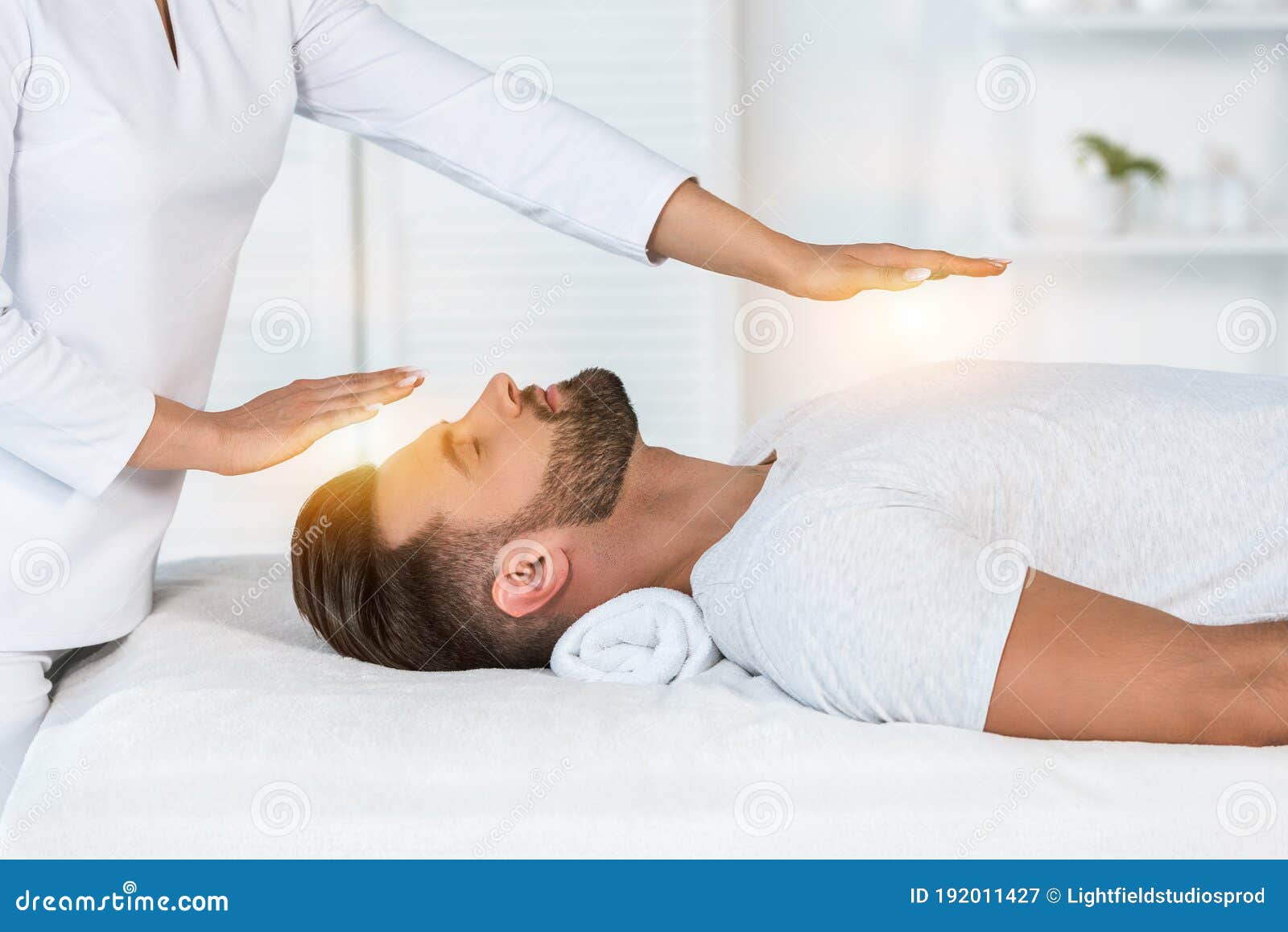 View of Healer Putting Hands Above Head while Healing Handsome Man on