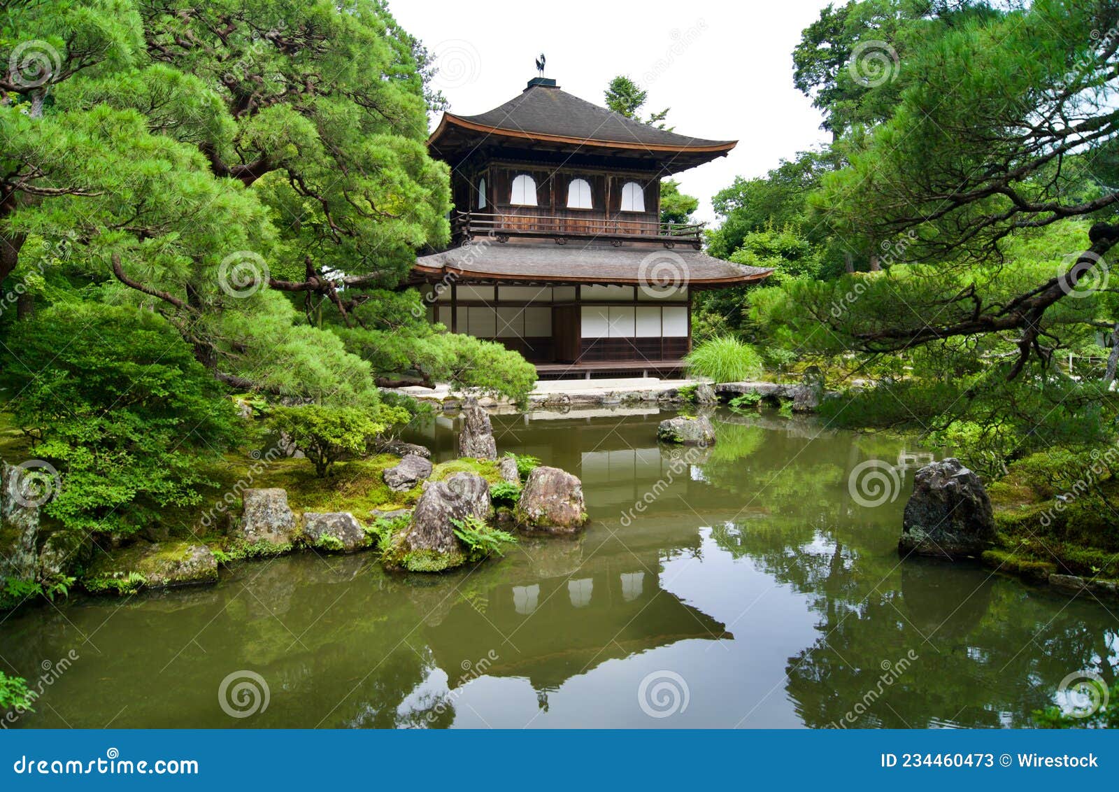 view of higashiyama jisho-ji temple among the amazing nature in front of a  pond in kyoto, japan