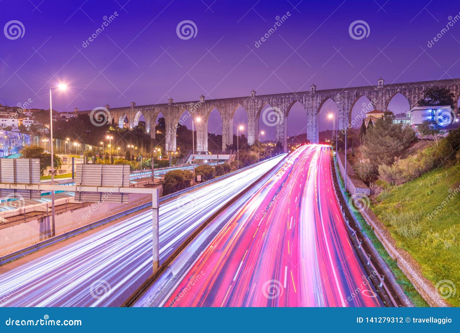 view of highway with car traffic and light trails. the aguas livres aqueduct aqueduto das ÃÂguas livres in lisbon, portugal