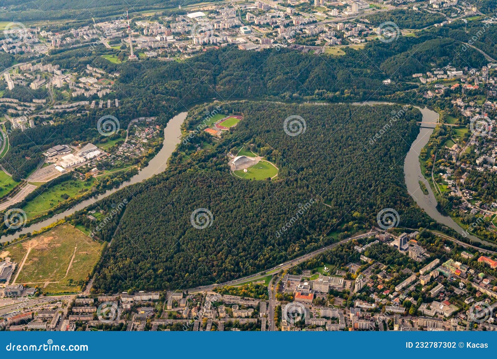 view from hot air balloon on famous vingis park in vilnius, lithuania with huge modern amphitheater in center of park surrounded