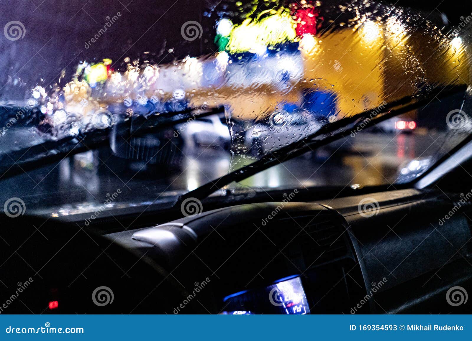 View from Inside the Car of the Windscreen Wiper Cleaning during Night