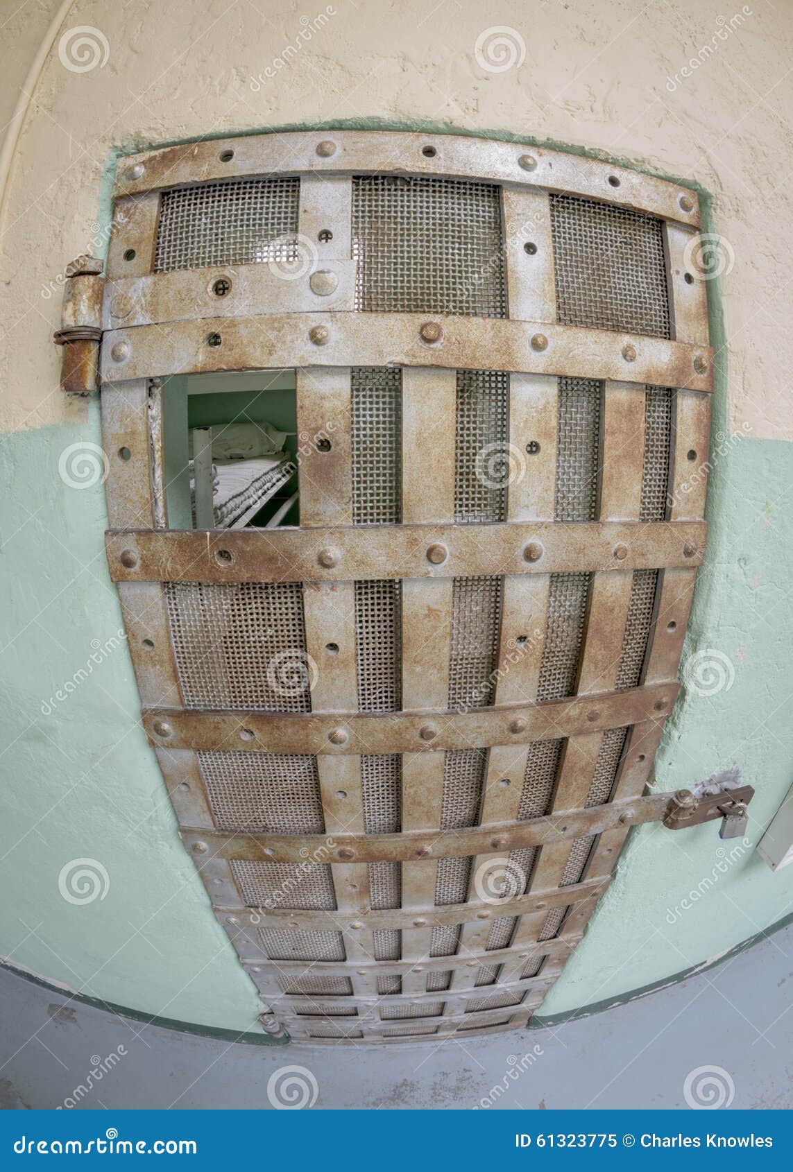 View of a Jail Cell Bed through the Bars Stock Image Image of
