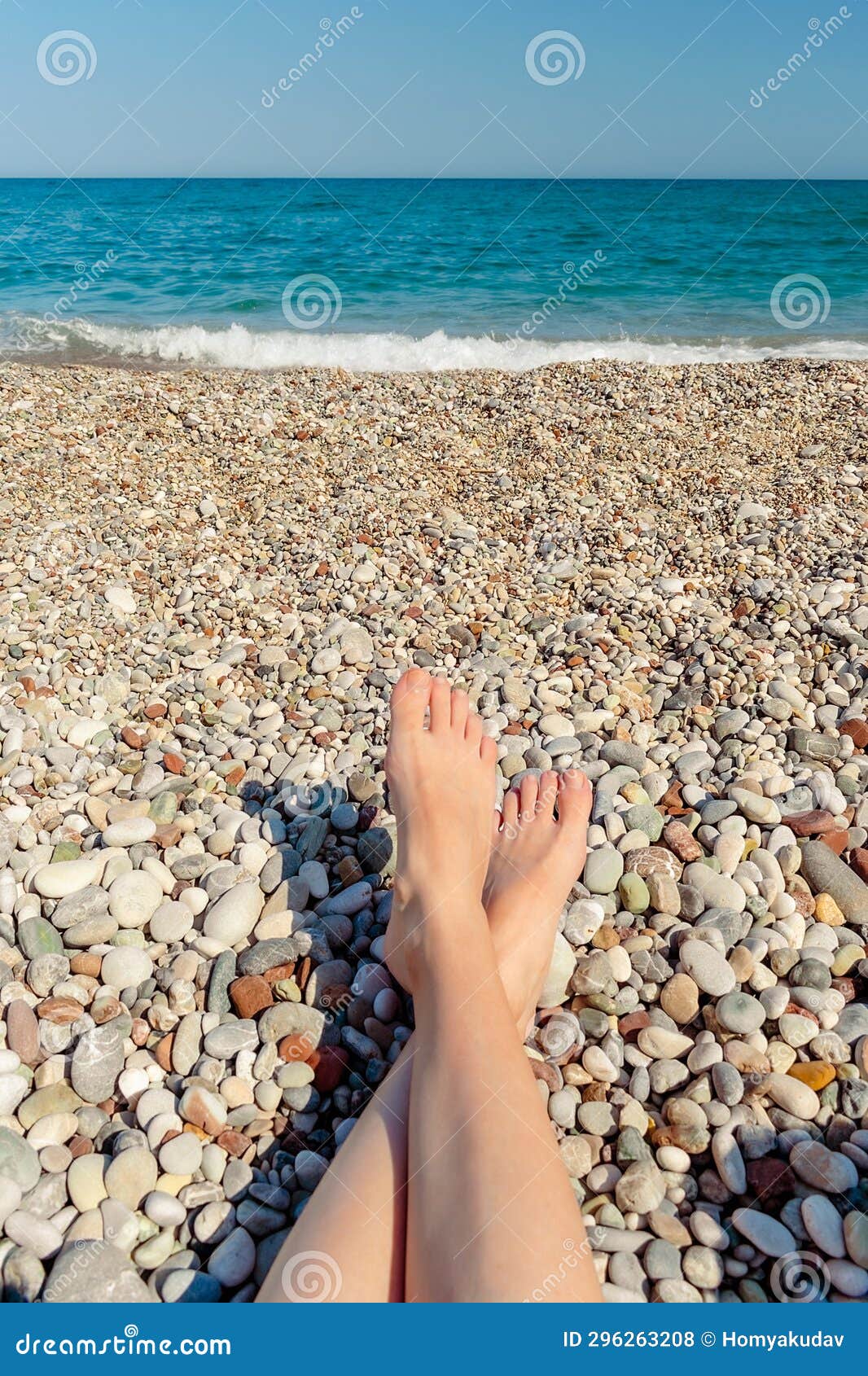 View Of The Legs Of A Girl Lying On The Beach And Resting Stock Photo