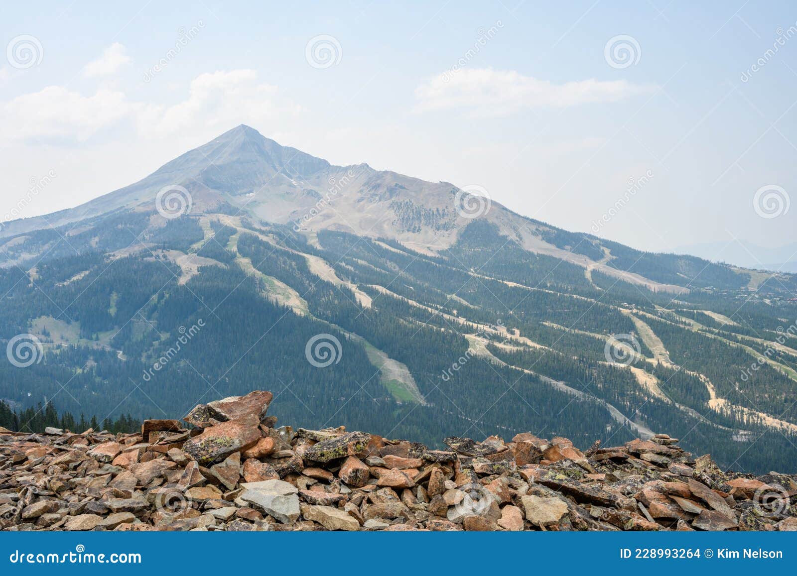 view of lone mountain peak and sky runs, in the summer, from the peak across the valley, big sky, montana