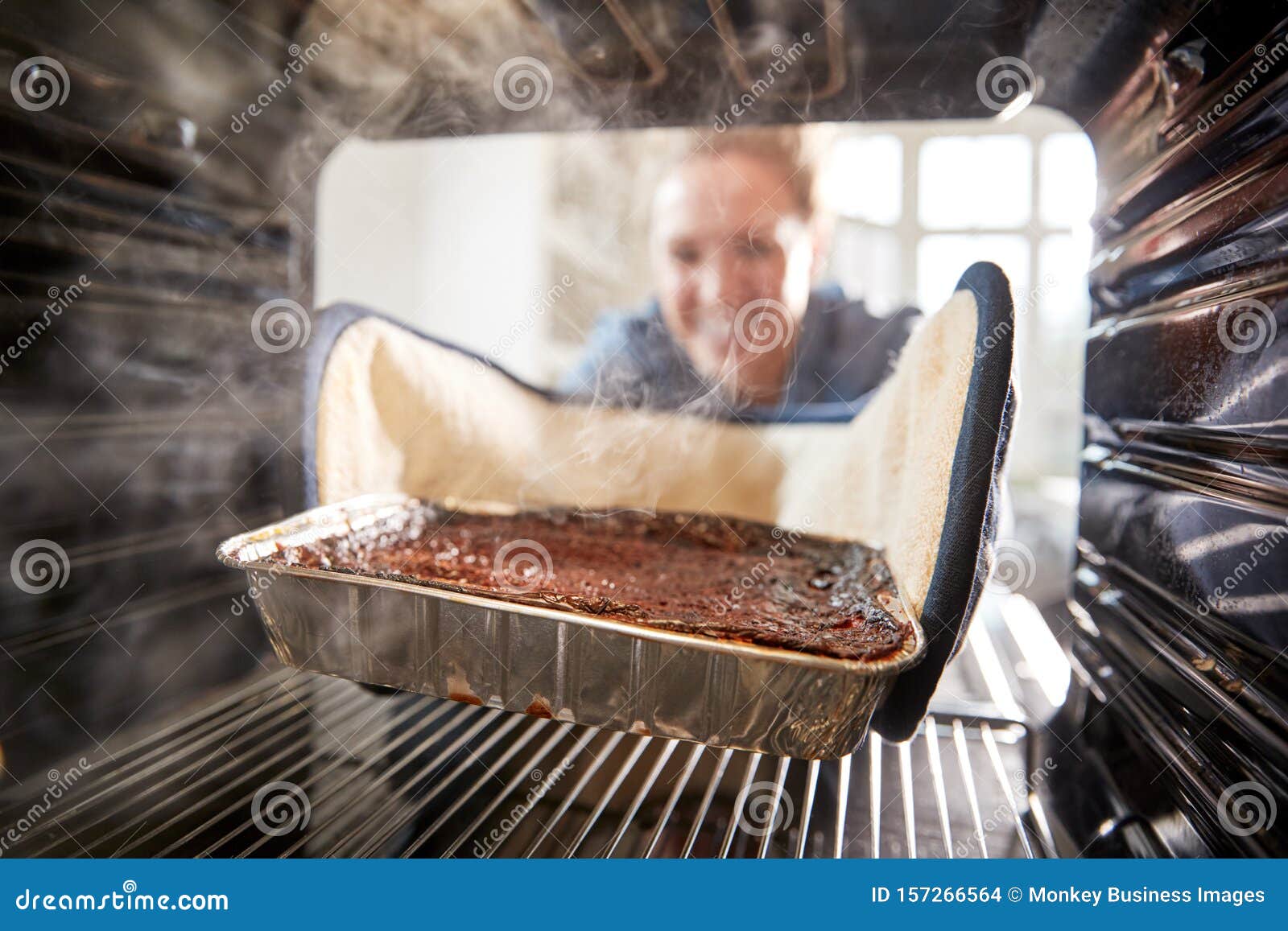 View Looking Out from Inside Oven As Woman Burns Dinner Stock Photo