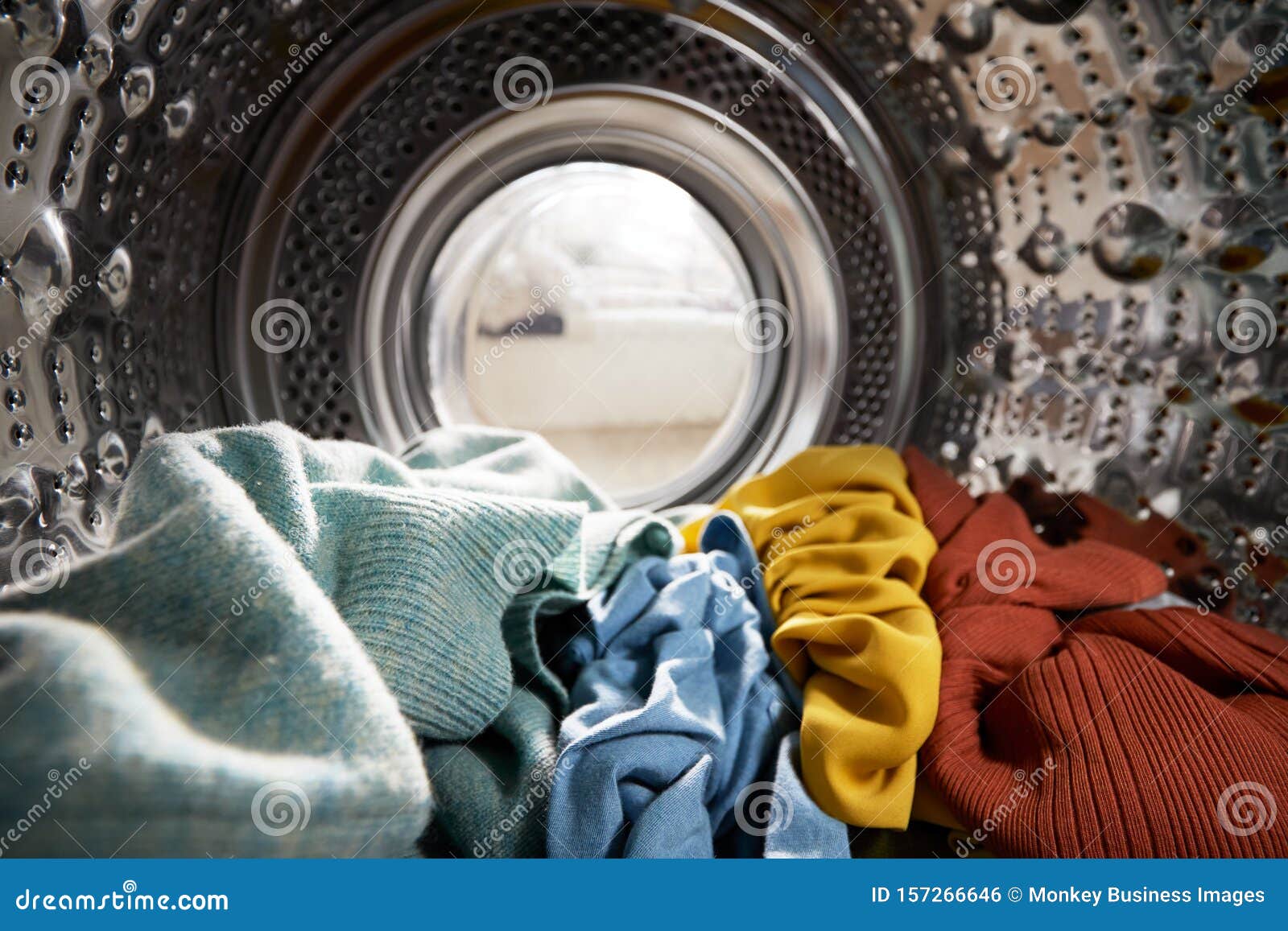view looking out from inside washing machine filled with laundry
