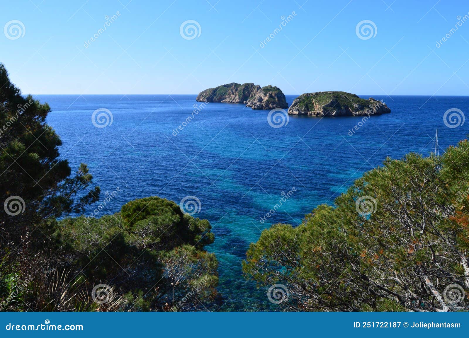 view of malgrats islands from mallorca with waves from the mediterranean sea