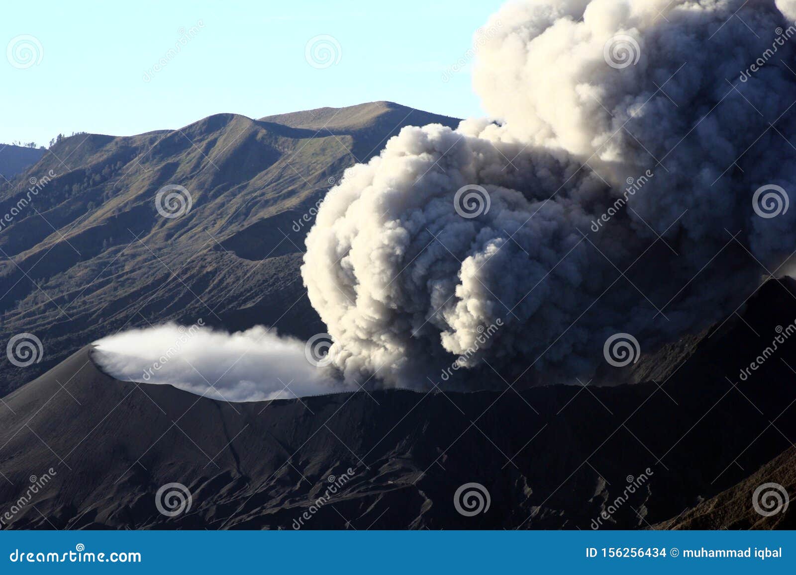 the view of mount bromo being erupted in the morning