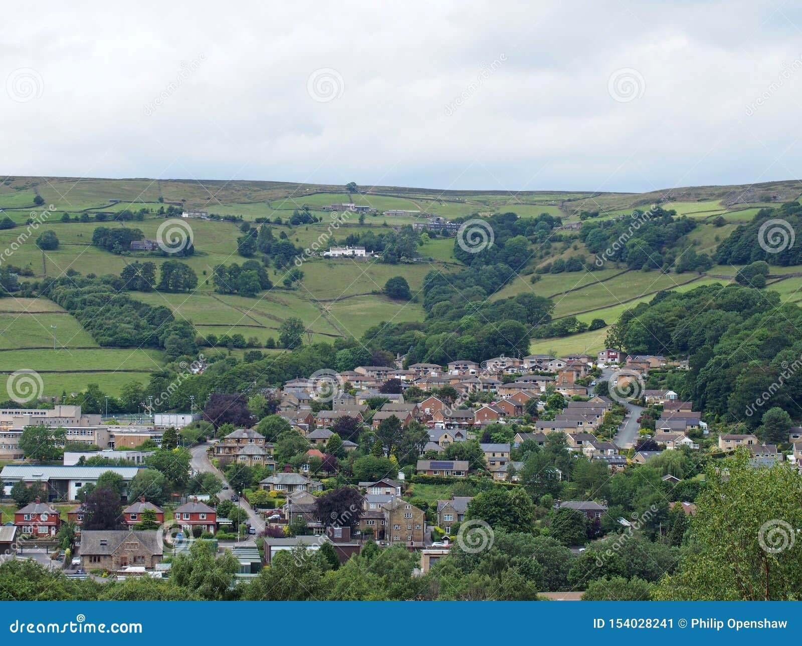 mytholmroyd from above in west yorkshire countryside surrounded by trees and fields and farms