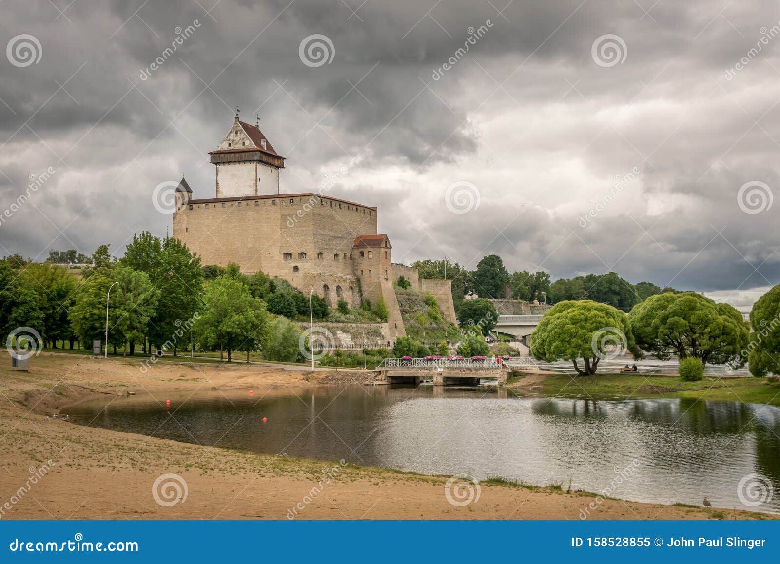 A View of Narva Castle with Storm Clouds Near a Beach Stock Image A View of Narva Castle with Storm Clouds Near a Beach Stock Image